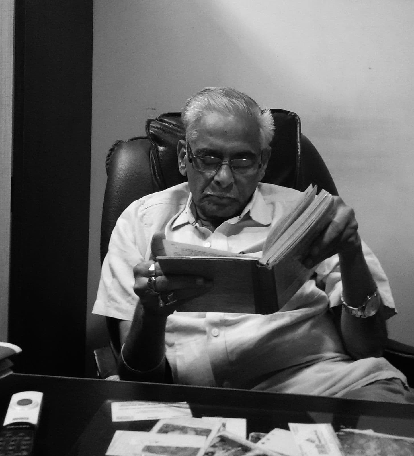 Sri S. Hanumanth Rao reading at his desk
